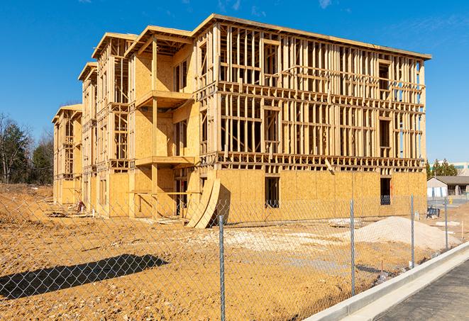 a close-up of temporary chain link fences enclosing a job site, signaling progress in the project's development in Melrose Park